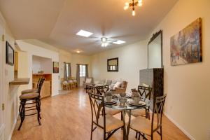 a dining room and living room with a table and chairs at Comfy Albuquerque Townhome Less Than 6 Mi to Downtown in Albuquerque