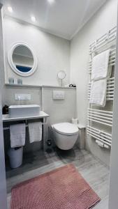 a bathroom with a white toilet and a sink at Maison Lily Apartment 4 in Bad Lauterberg