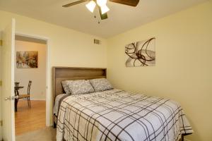 a bedroom with a bed and a ceiling fan at Comfy Albuquerque Townhome Less Than 6 Mi to Downtown in Albuquerque