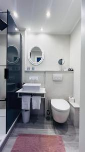 a bathroom with a toilet and a sink at Maison Lily Apartment 4 in Bad Lauterberg