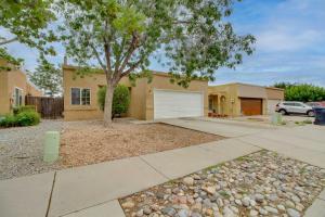 a house with a tree and a driveway at Comfy Albuquerque Townhome Less Than 6 Mi to Downtown in Albuquerque