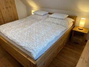 a bed with two pillows on it in a room at Chalet Schäftal in Langau +24 photos