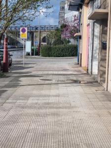 an empty street with a sign on the side of a building at Apartamento Corbaceiras in Pontevedra