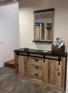 a bathroom with a wooden vanity with a mirror at Chalet Schäftal 