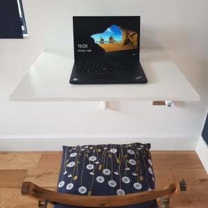 a laptop computer sitting on top of a white table at Modern 1-bed apartment, plus parking, near Oxford and the JR in Oxford +10 photos