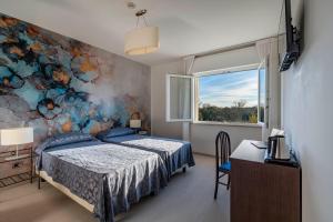 Postel nebo postele na pokoji v ubytování Hotel Sorriso