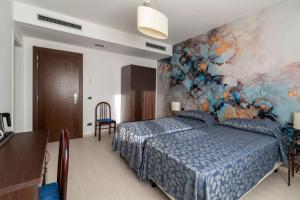 Postel nebo postele na pokoji v ubytování Hotel Sorriso