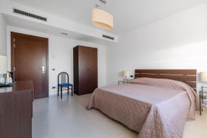 Postel nebo postele na pokoji v ubytování Hotel Sorriso