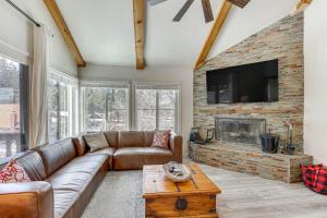 a living room with a couch and a fireplace at Big Bear Lake Condo with Deck, Steps to Ski Lift in Big Bear Lake