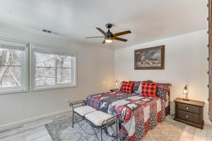 a bedroom with a bed and a ceiling fan at Big Bear Lake Condo with Deck, Steps to Ski Lift in Big Bear Lake