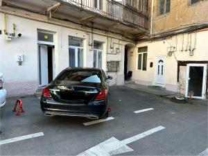 a car parked in a parking lot next to a building at Zen Studio - Edge of Old Town with Free Private Parking in Braşov