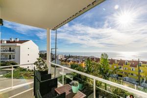 a balcony with a view of the ocean at Vibing & Liming Ericeira in Ericeira