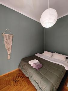 a bedroom with a bed and a light fixture at Apartment Thisio in Athens
