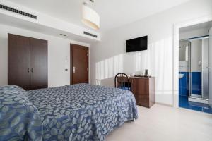 Postel nebo postele na pokoji v ubytování Hotel Sorriso