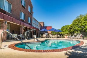 a swimming pool in front of a building at SpringHill Suites Dallas Arlington North in Arlington