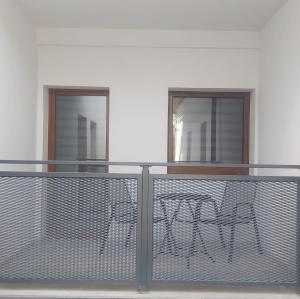 a balcony with a table and two windows at Studio Třeboň in Třeboň