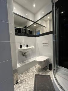 a bathroom with a toilet and a sink and a tub at Adventure Base A&B in Stronie Śląskie