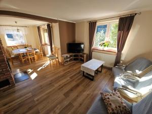 a living room with a couch and a table at Zawoja 1895 sauna bania in Zawoja