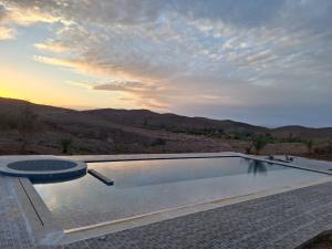 a swimming pool with a view of the mountains at Kasbah Zitoune in Ouarzazate