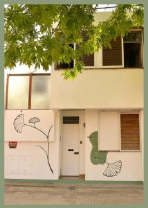 a building with a door with a painting on it at Ginkgo Hostel La Plata in La Plata