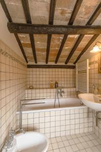 y baño con bañera y lavamanos. en La Rocca - Palazzo Pallotti, en Lubriano