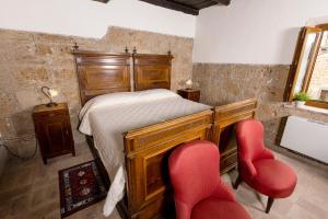 Postel nebo postele na pokoji v ubytování La Rocca - Palazzo Pallotti