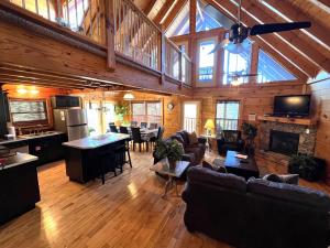 a living room with couches and a kitchen and a living room with at Airport Runway 33 in Pigeon Forge