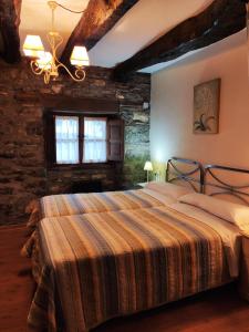 a bedroom with a large bed in a building at Apartamentos rurales Casa Xepo in Rengos