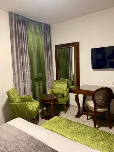 a hotel room with a bed and a desk and chairs at Guesthouse Villa Vice in Split