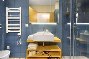ein blaues Badezimmer mit Waschbecken und Dusche in der Unterkunft Casa Marques Apartments in Aveiro + 39 Fotos