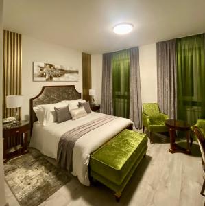 a bedroom with a large bed and a green chair at Guesthouse Villa Vice in Split