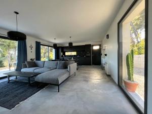 a living room with a couch and a table at Villa Casa Papey in Draguignan