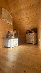um quarto vazio com paredes de madeira e piso de madeira em Chatka Dziadka Sudety em Stary Gieraltow