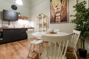 a kitchen with a white table and chairs at Cosy Apartment In Party District K30 in Budapest