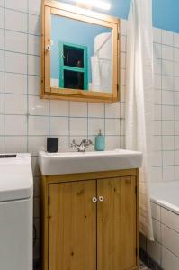 a bathroom with a sink and a mirror at Cosy Apartment In Party District K30 in Budapest