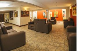 a waiting room with couches and chairs in a building at Hotel Asturias in Arequipa