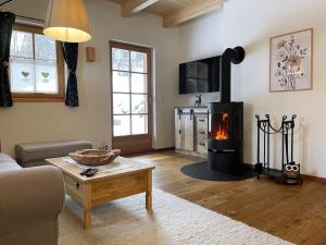 a living room with a wood burning stove in it at Chalet Schäftal in Langau