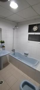 a bathroom with a bath tub and a toilet at My Home Stay apartment 2 in Abu Dhabi