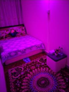 a pink room with a bed and a table at My Home Stay apartment 2 in Abu Dhabi