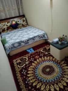 Un dormitorio pequeño con una cama y una alfombra. en My Home Stay apartment 2, en Abu Dabi