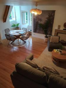 uma sala de estar com um sofá e uma mesa em duplex de charme à Dinan em Taden