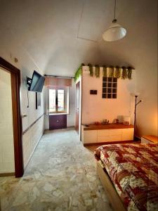 a bedroom with a bed and a flat screen tv at Apulian Dream in Peschici
