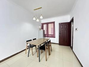 a dining room with a wooden table and chairs at Guangzhou Phantom Oasis Apartments - Canton Fair Exhibition Area in Guangzhou