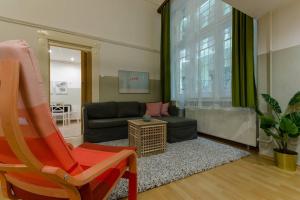a living room with a couch and a chair at DE LUX Studio Apartment In Historical Quarters in Budapest