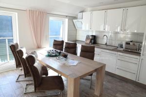 a kitchen with a wooden table and chairs at Holidayhaus Lütsche in Frankenhain