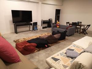 a living room with a couch and a flat screen tv at Y.U.A.N in Kluang