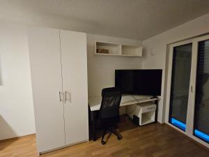a room with a desk with a computer and a chair at State of the Art Apartment in the City Center Nürnberg in Nuremberg