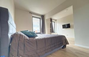 a bedroom with a bed and a large window at Station 64 A3 Bruxelles-Charleroi-airport in Charleroi