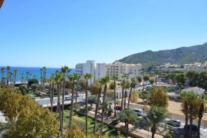 a city with palm trees and buildings and the ocean at Ibo beach apartment Albir in Albir