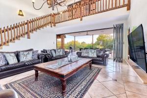 a living room with a couch and a table at Shasha Lodge, Mabalingwe Game Reserve in Mabula